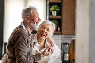Happy senior couple having fun in the kitchen
